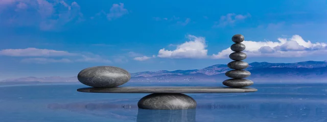 Fototapeten Zen-Steine reihen sich von groß nach klein im Wasser mit blauem Himmel. 3D-Darstellung © viperagp