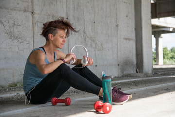 Slim muscular athlete woman resting after workout