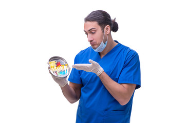 Young handsome doctor with syringe isolated on white