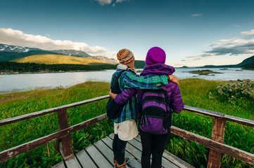 Womans walking in a balcony with a beautiful landscape in the background. Ushuaia, Argentina
