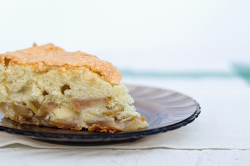 piece of cake. apple pie on a dark glass plate on white background