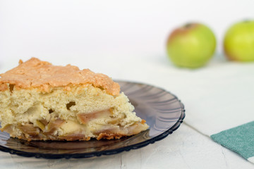 apple pie on a plate. apple pie on a dark glass plate with fresh fruits on white background