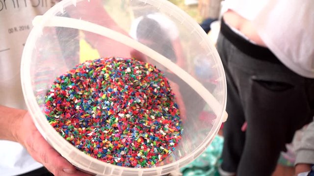 Colorful recycled bottle tops in hobbock. 4k video