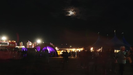 Music festival nightlife with moon and cloudy sky on background in Timelapse. 4k video