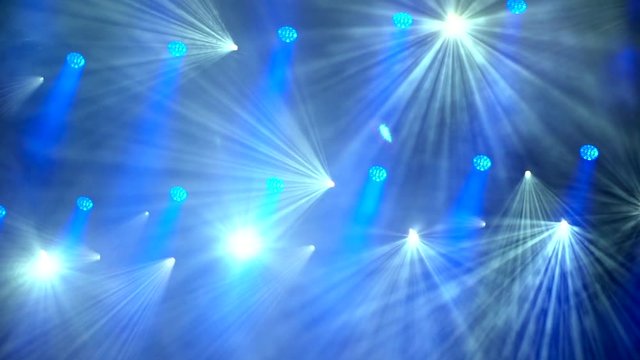 Blue stage lights shining in smoke during concert. 4k video