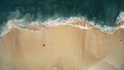 Aerial Top Drone View on Ocean Waves and White Sand Beach. Crystal Water Landscape in Tropical Bali...