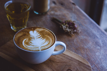 coffee hot drink cappucino latte art on wood vintage table , coffee time on wood background cafe