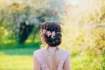 Photo of a stylish evening hairstyle for long hair, which are collected in an elegant bun with...