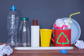 Recycling symbol drawn on the mug and different garbage, eco concept.