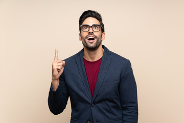Handsome young man over isolated background pointing up and surprised