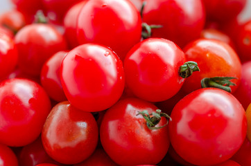 Small red cherry tomatoes background. Fresh vegetables.