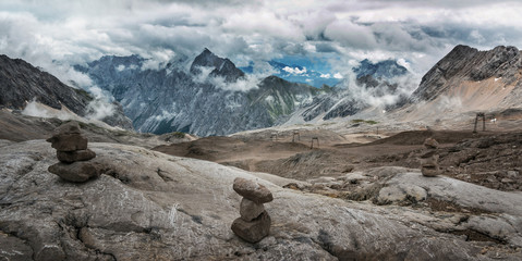 Stones cairn bridging on Zugspitze peak, Alps, Germany