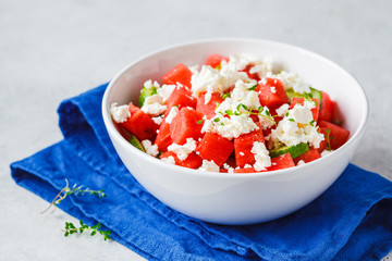 Watermelon, cucumber and feta cheese salad in white bowl.