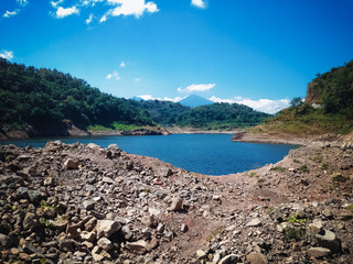Natural Environment Ground Rock Fragments And Lake Water Of Titab Ularan Dam Between The Hills, North Bali, Indonesia