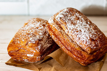 Puff bun with icing sugar on a white background.