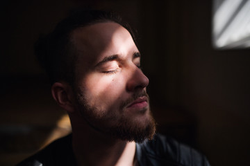 A portrait of young man indoors, a close-up.