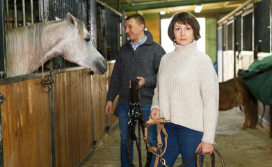 Portrait of couple standing at stable