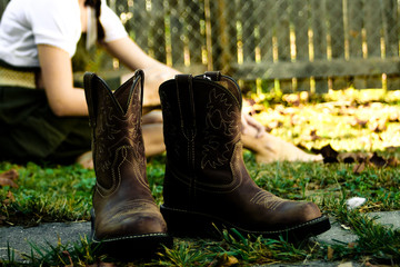 cowboy boots on the grass
