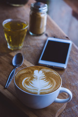 coffee hot drink cappucino latte art on wood vintage table , coffee time on wood background cafe