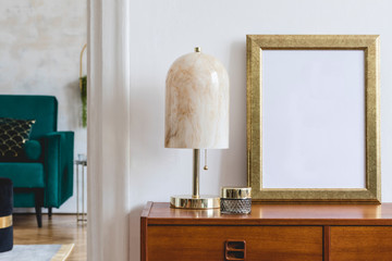 Stylish composition of open space interior with gold mock up frame, retro wooden commode, velvet...