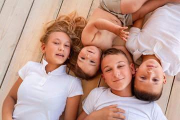 Happy little kids lying on the floor indoors