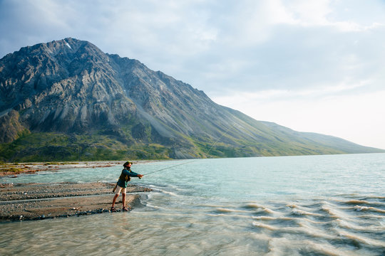 A man fly fishing on Turquoise Lake in Lake Clark National Park and Preserve, Alaska, USA