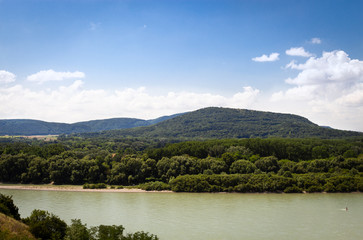 Fototapeta na wymiar Mountain surrounded by Danube river, near Devín castle and Bratislava, Slovakia, Europe. July 14, summer 2019