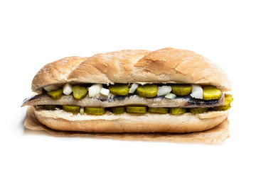 Traditional Dutch sandwich with herring and pickles isolated on white