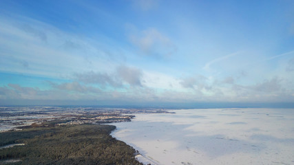 Fototapeta premium Aerial view of white winter frozen lake from above. bird's eye, drone shot. amazing natural background