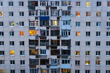 Lighted windows and balconies of an old night residential building
