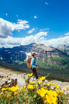 A woman hiking the loop trail from Two Medicine over Dawson Pass, with Mount Phillips in the background, Glacier National Park, Montana, USA.
