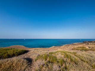 View of the beautiful San Lorenzo rock beach, in the southern Sicily, Italy. The shot is taken during a sunny summer day