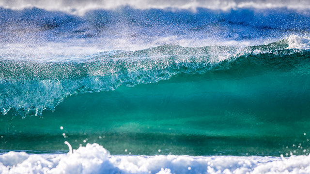 Australia, Queensland, Sunrise Beach. A wave breaks on the shore.