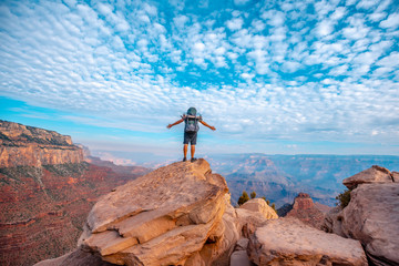 A young man with open arms on a viewpoint of the descent of the South Kaibab Trailhead. Grand Canyon, Arizona