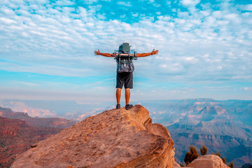 Detail of a young man with open arms on a viewpoint of the descent of the South Kaibab Trailhead. Grand Canyon, Arizona