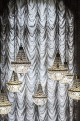 Crystal chandeliers on the background of curtains