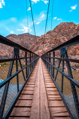 Fototapeta na wymiar The beautiful bridge that crosses the Colorado River at the end of the South Kaibab Trailhead trek. Grand Canyon, vertical photo
