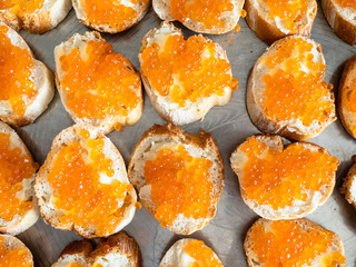 many butterbrots with red caviar on tray