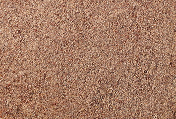 Ground carob (Ceratonia siliqua) powder background and texture, top view
