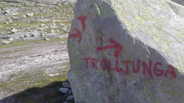 July 26, 2019. Norway tourist route on the trolltunga. People tourists go hiking in the mountains of Norway in fine sunny weather to thetrolltunga. Hiking backpack theme