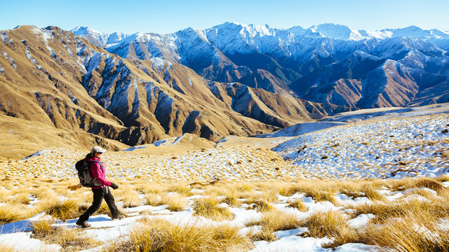 New Zealand, Otago. A woman hiking the Moonlight Track near Queenstown.