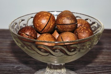 nuts in a bowl on wooden background