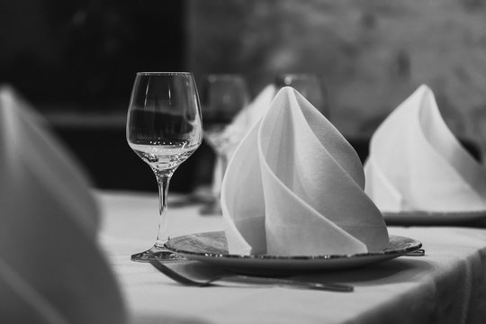 Empty glasses set in restaurant. Black and white picture