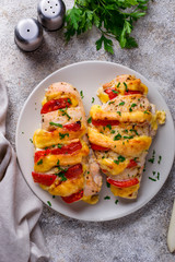 Baked chicken breasts with cheese and tomato