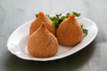 coxinha de frango, typical brazilian chicken croquette on white dish