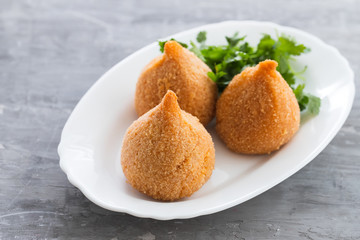 coxinha de frango, typical brazilian chicken croquette on white dish