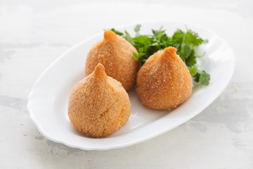 coxinha de frango, typical brazilian chicken croquette on white dish