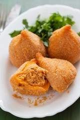 coxinha de frango, typical brazilian chicken croquette on white dish