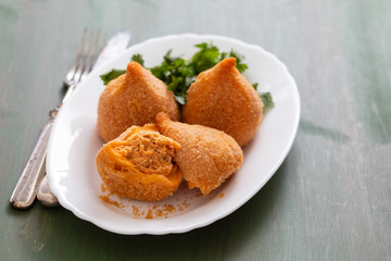 coxinha de frango, typical brazilian chicken croquette on white dish