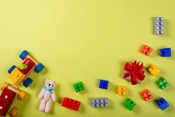 Various children's toys on green background. Space for text in the center of the image.